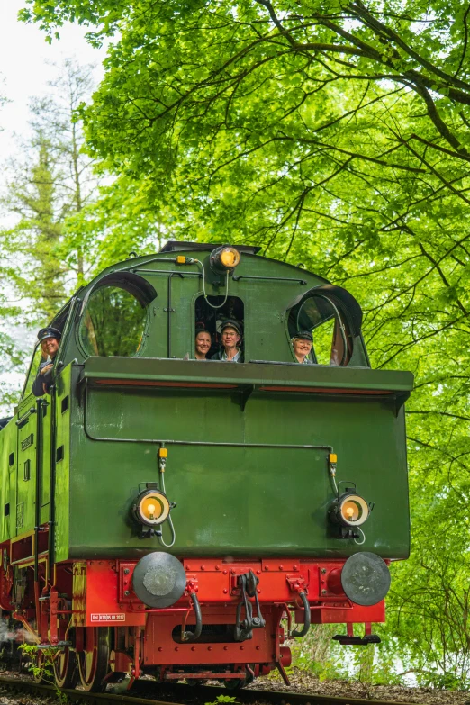 people are riding in an unusual looking train