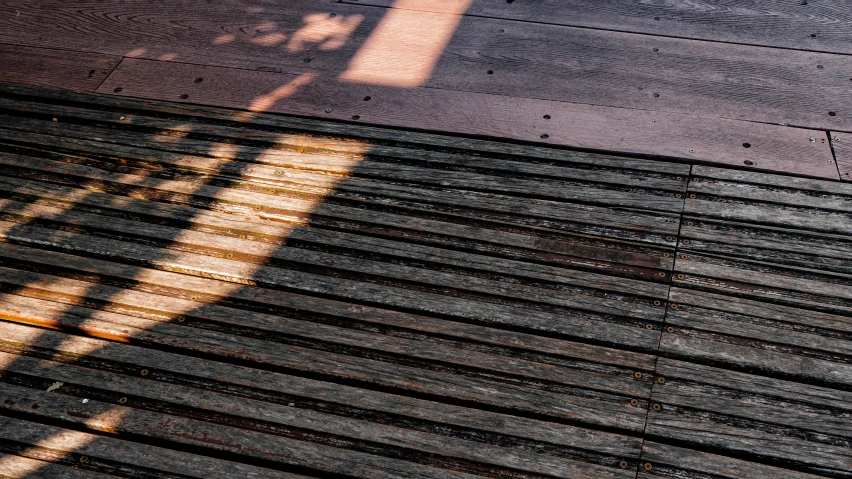 the shadows on the wooden roof are cast by the sun