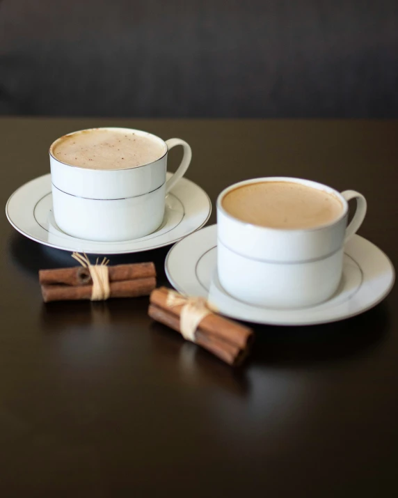 the white cup and saucer on the black table