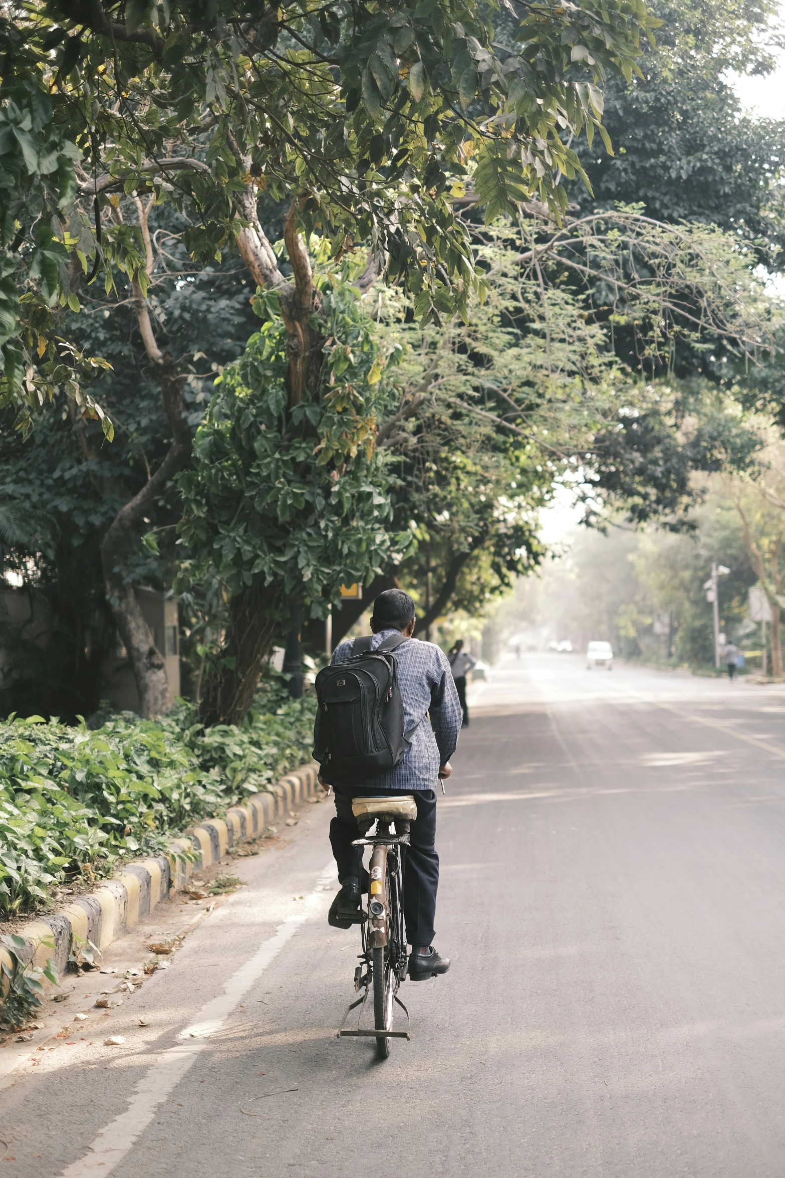 the man is riding his bike down the street