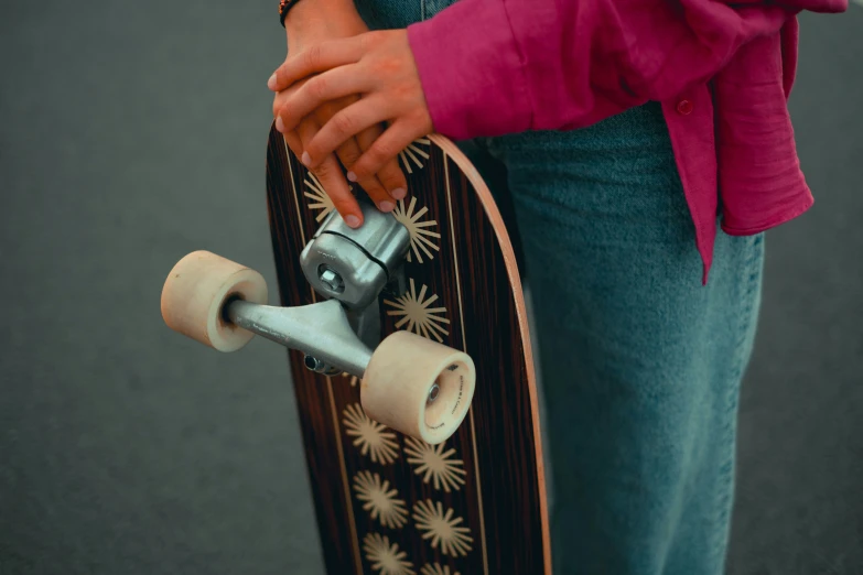 a woman is holding her skateboard with a small lock