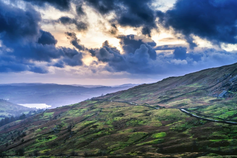 a road is in the mountains in front of clouds