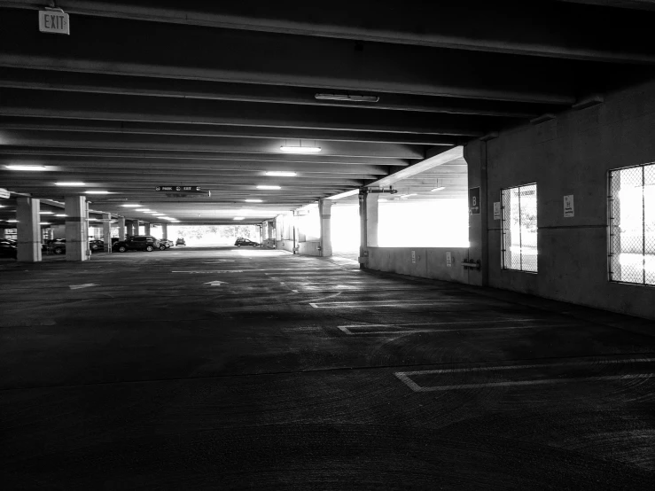 a dark parking garage with multiple parking spaces