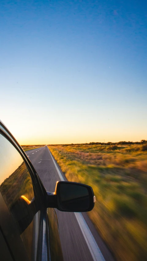 view of road during sunset from car window