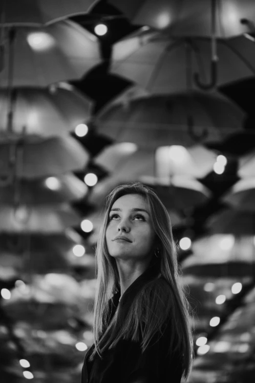 a woman is standing alone in a long room