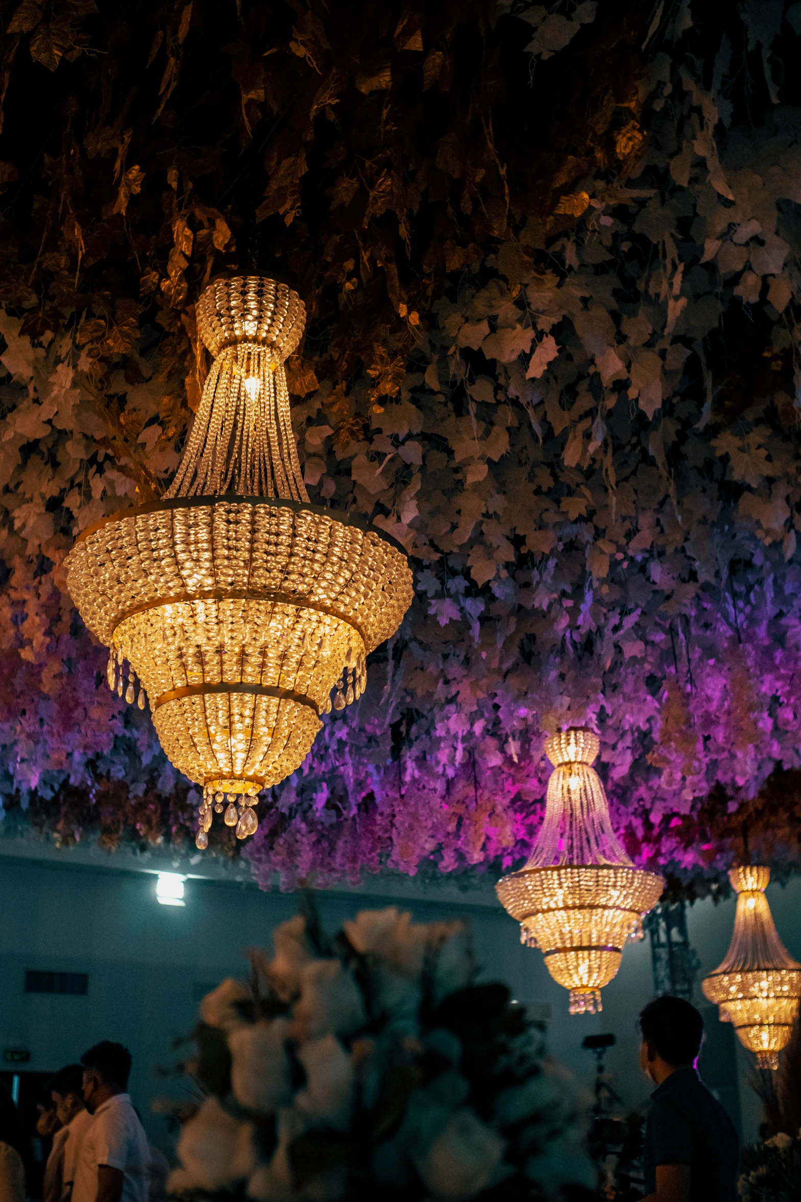 a room filled with different chandeliers hanging from the ceiling