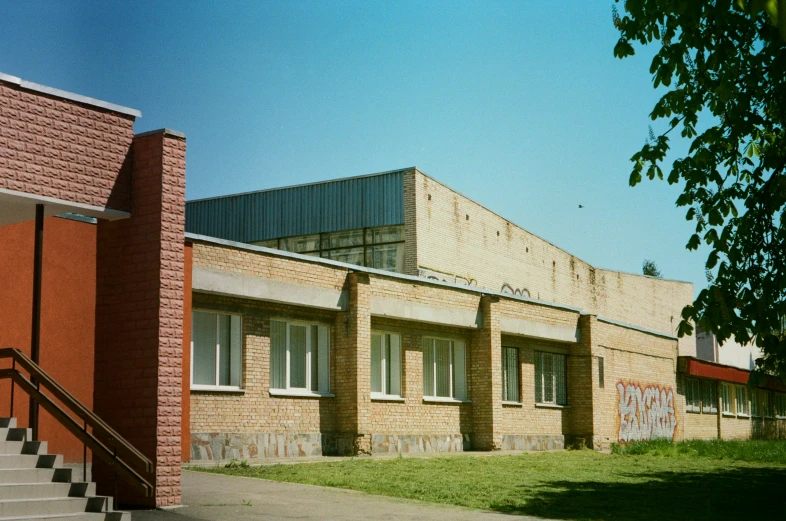 an old abandoned building sits in front of a brick and concrete building