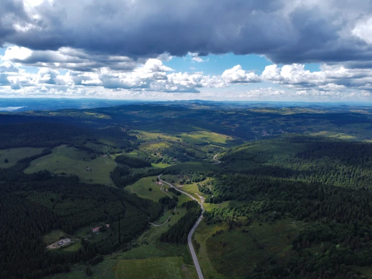 an aerial s of a dirt road through the mountains