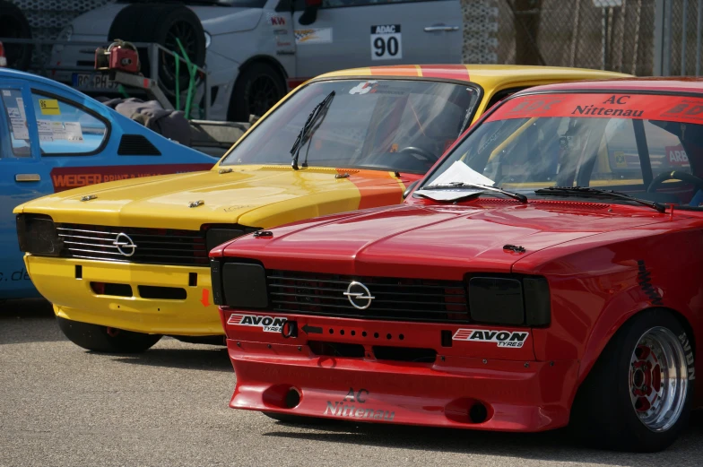 there are three red and yellow cars that can be found at this event