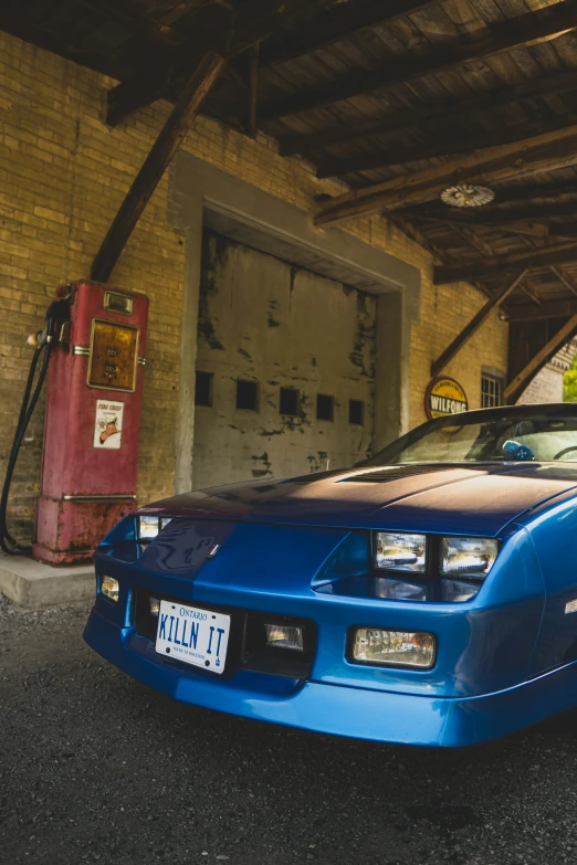 a car parked in a garage next to another car