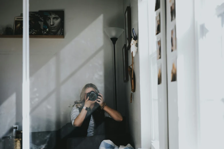 woman taking po in living room of house