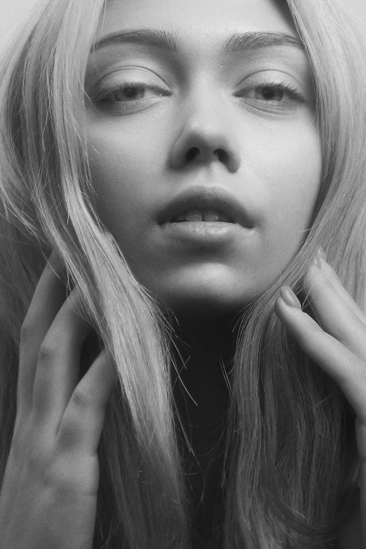 a woman with long hair posing for a black and white picture