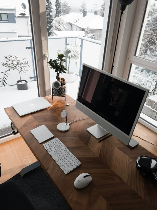 a desk with a computer, keyboard and mouse on it