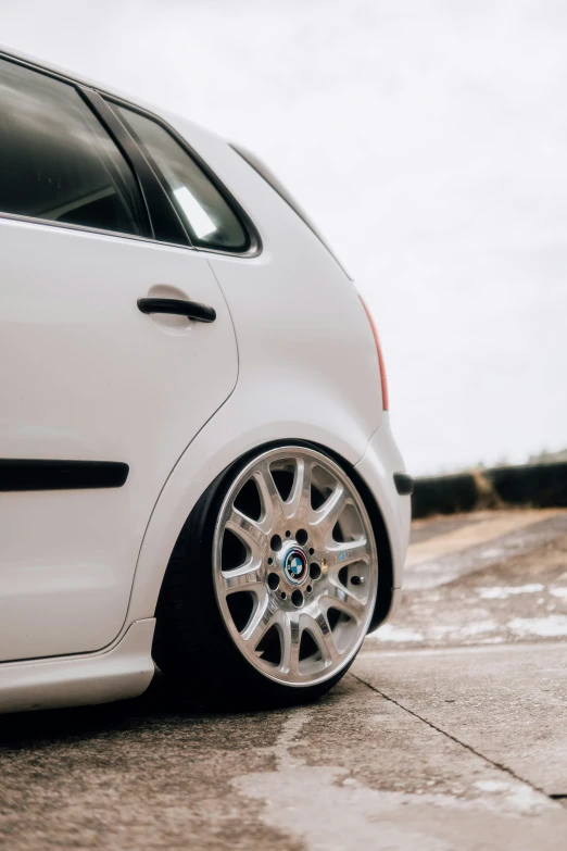 a small white car parked by the street