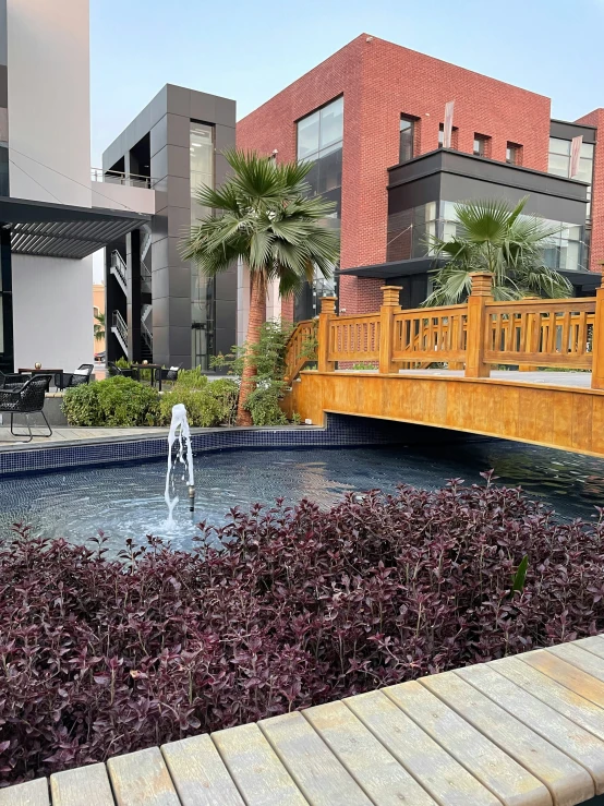 a water fountain in front of a row of buildings