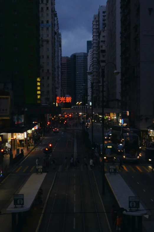 city at night with lights on train tracks and buildings