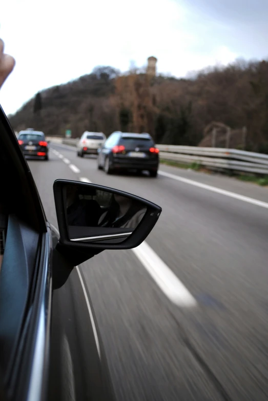 an suv driving down the highway on a cloudy day