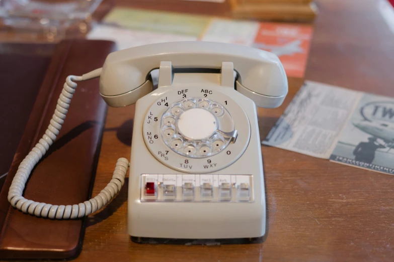 a rotary phone sitting next to a phone