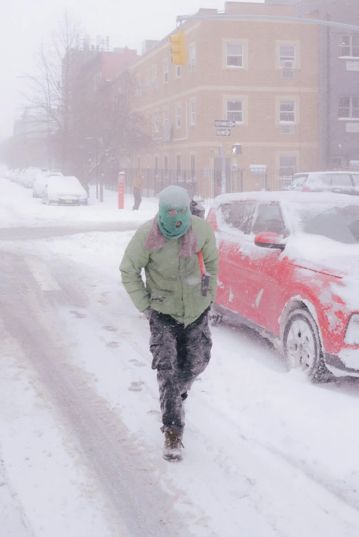 a man walking down the street in a snowy street