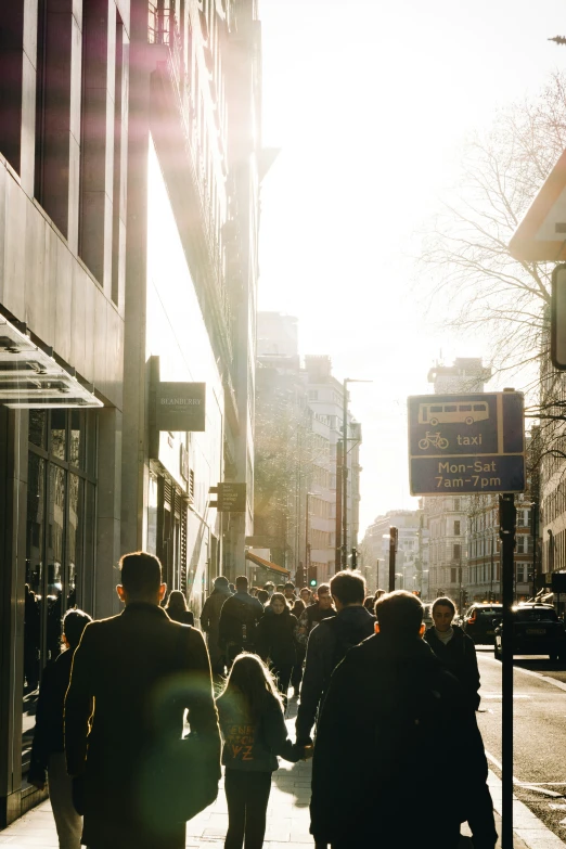 people walking down the street near buildings and signs