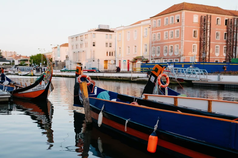 two boats parked side by side in the water