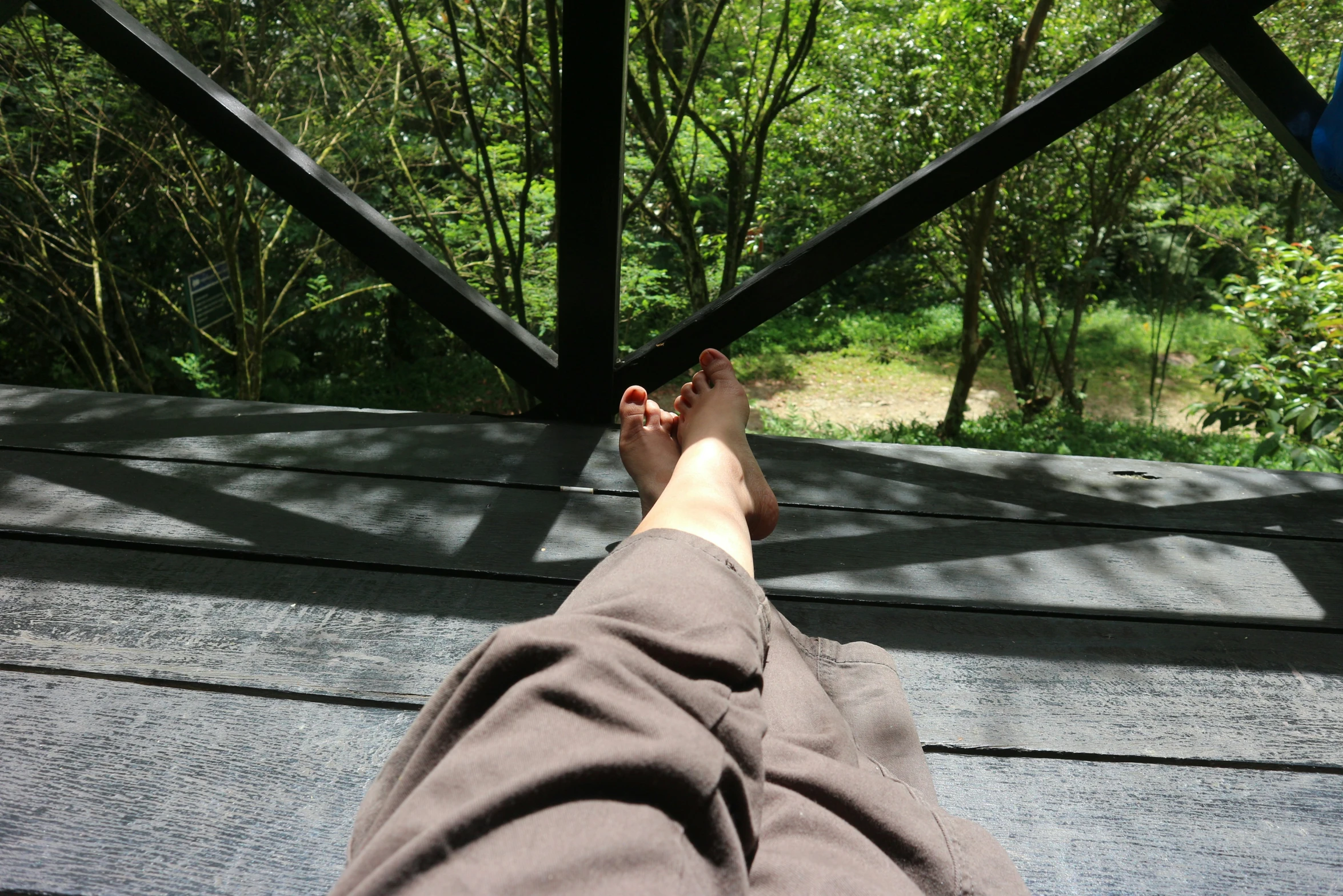 a man's feet up on a metal beam