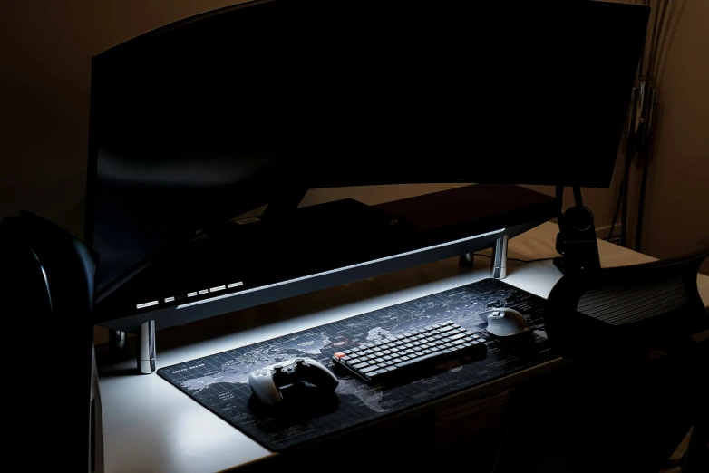 a black and white computer desk and keyboard on top of it