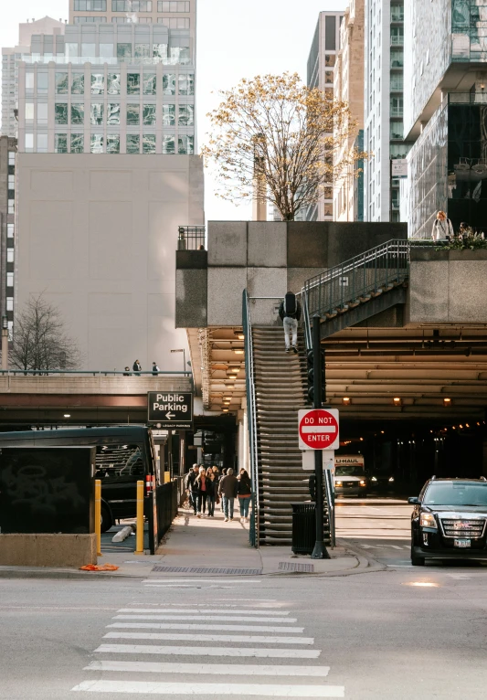 people crossing a street and a van is parked next to the stairs