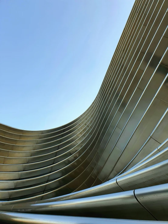 a big long metal pipe near the side of a building