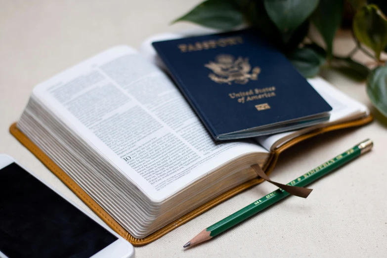 an open book, two smartphones, and an additional passport