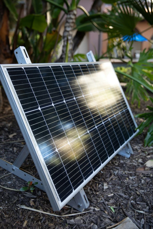 this solar panel is sitting on the ground