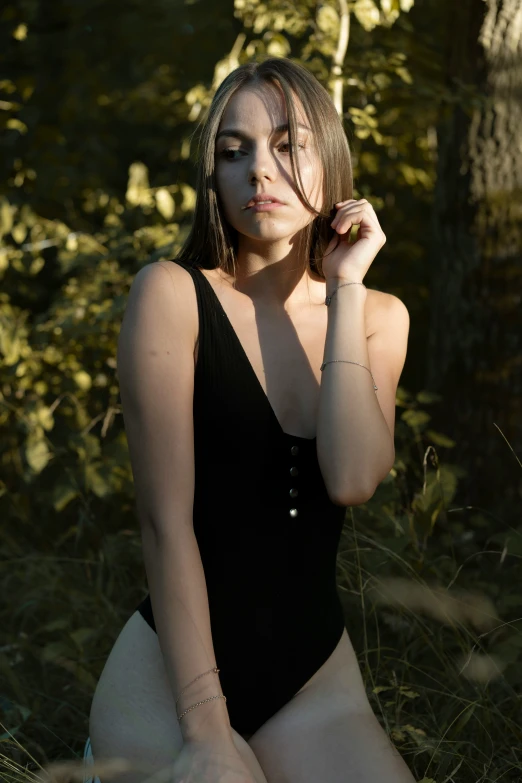 a girl in a bathing suit in the woods