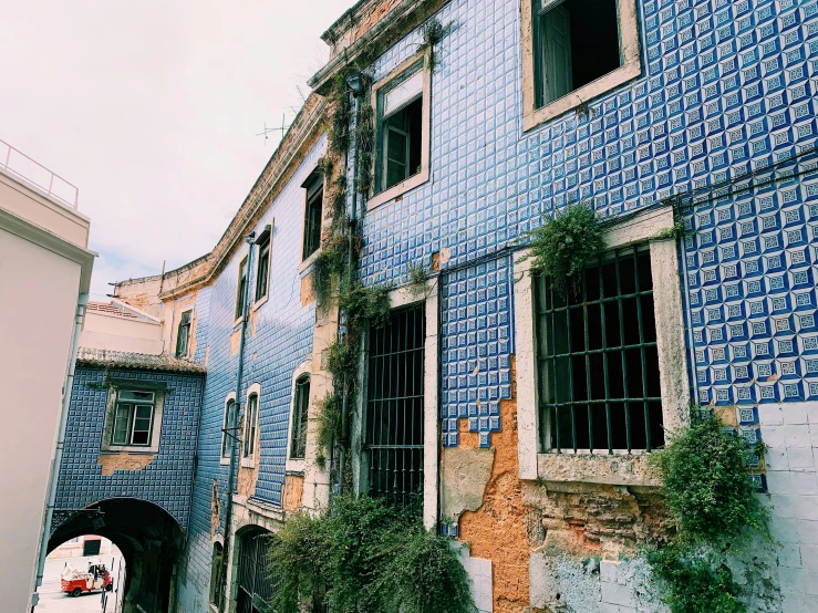 an old building with blue tiles on it