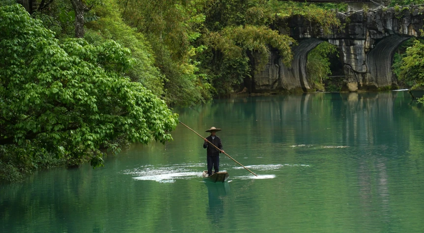 a person standing on some water with a fishing pole