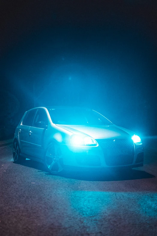 a car with its lights turned on at night