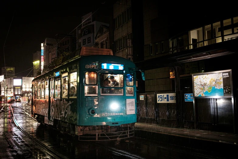 a trolley train on tracks in the rain