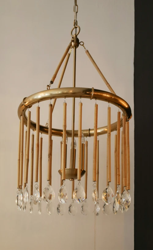 a close up of a light fixture with candles hanging from it