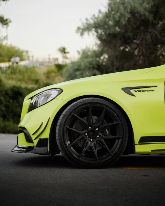 a yellow car sitting on the road