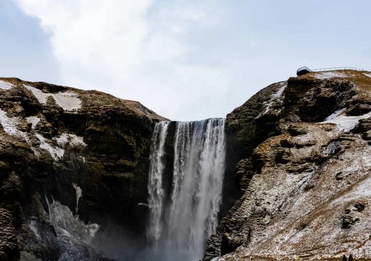 waterfall of water with people standing at the base