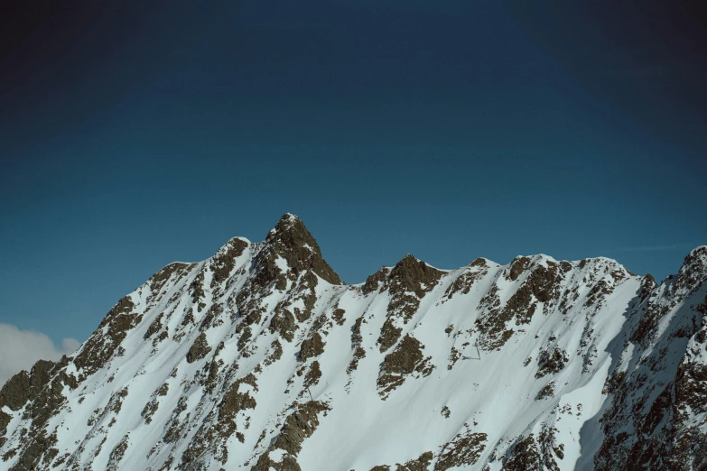 skiers are skiing up the mountain top in the snow