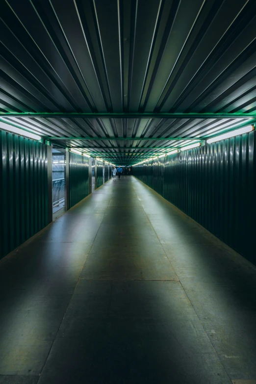 a tunnel with some walls painted dark green