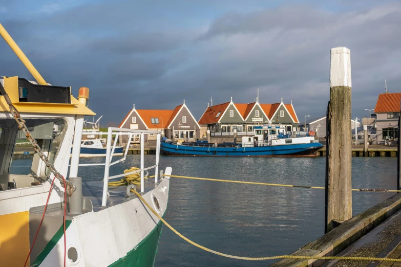 the water is calm and quiet next to a row of houses