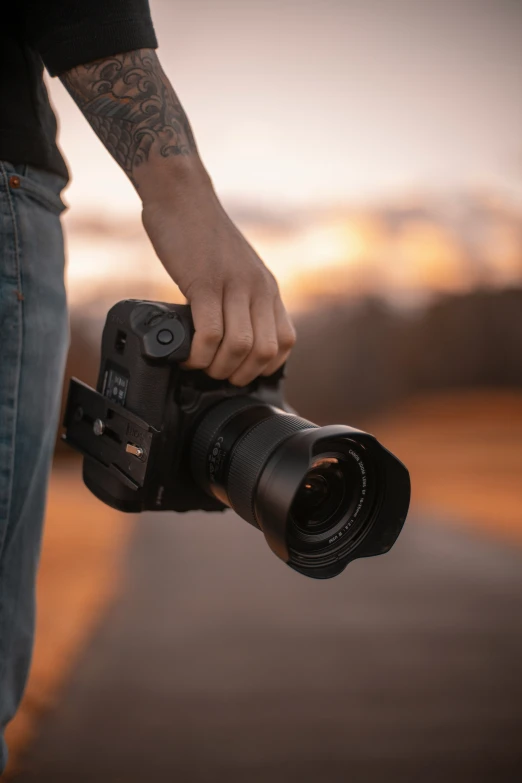 a man carrying a camera in his hand