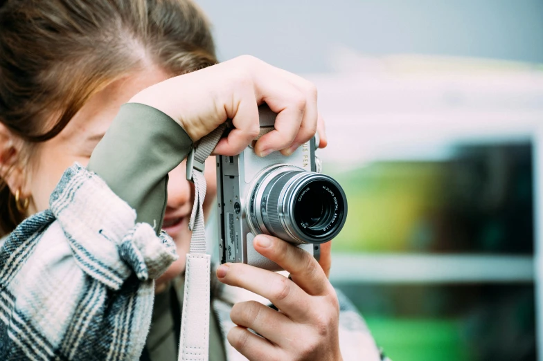 a woman holding a camera taking a picture