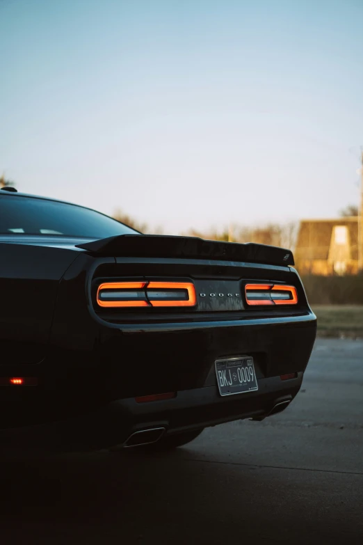 the rear end of a black dodge car