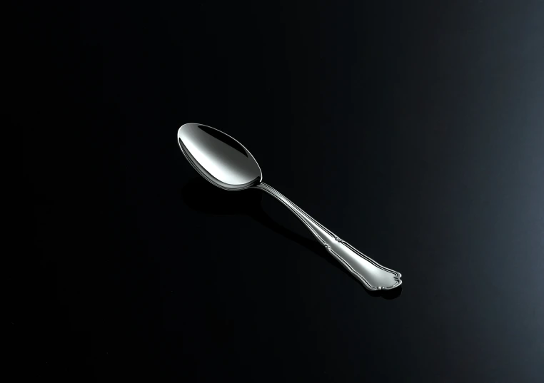 a spoon on top of a black table