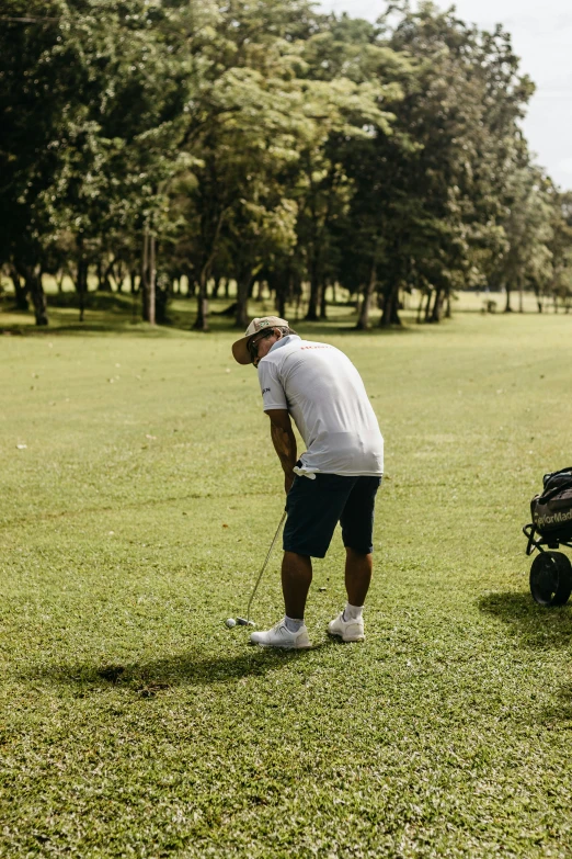 the man is taking a walk with his golf cart