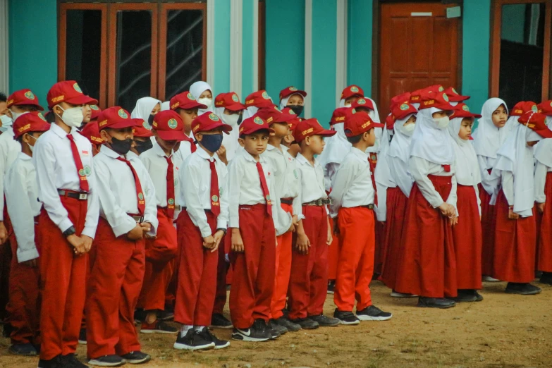 a group of young people wearing red and white outfits