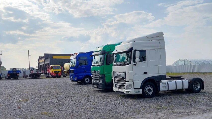 many trucks parked in a line next to each other