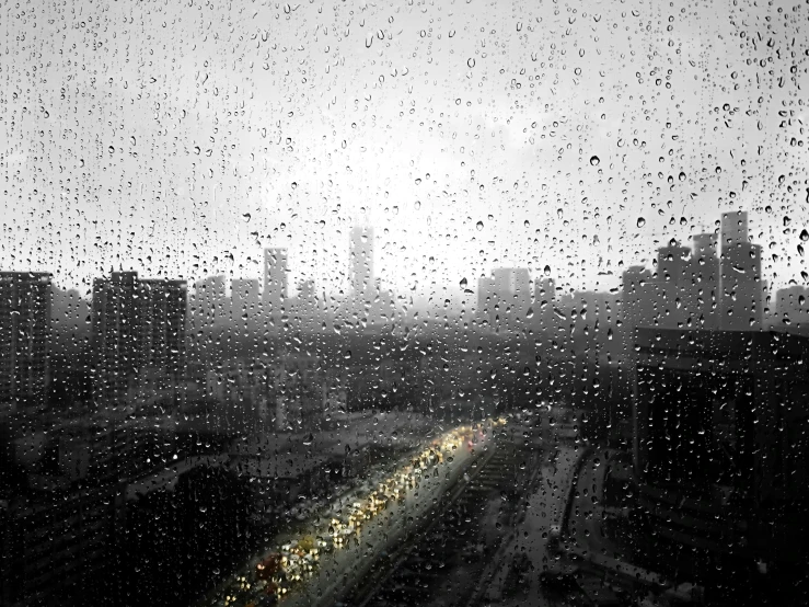 rain drops on the window and cityscape with skyscrs in background